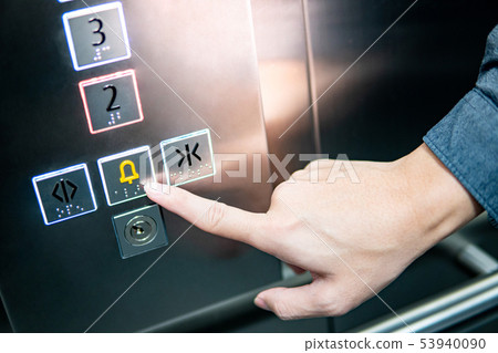 Male hand pressing on emergency button in elevator 53940090