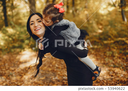 Cute and stylish family in a autumn park 53940622