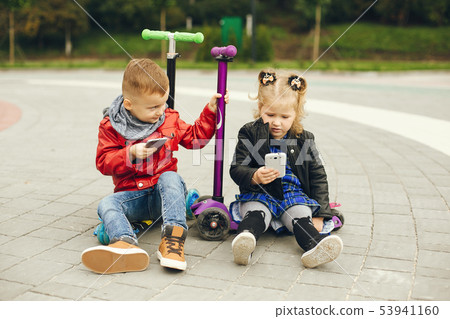 Cute child in a park playing on a grass Cute child in a park playing on a grass 53941160