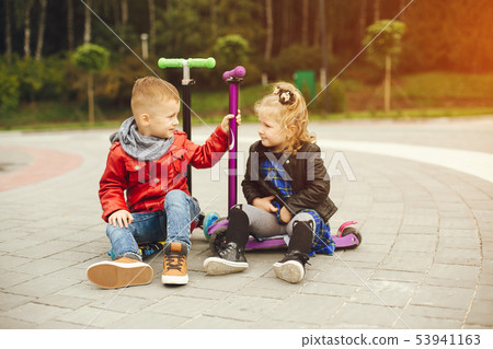 Cute child in a park playing on a grass 53941163