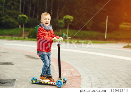 Cute child in a park playing on a grass 53941244