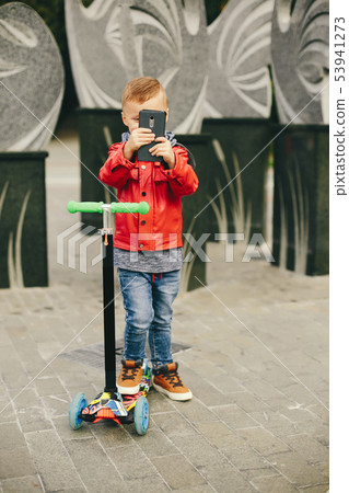 Cute child in a park playing on a grass 53941273