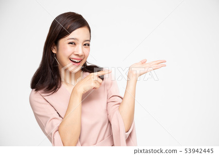Young elegant Asian woman smiling and pointing to 53942445