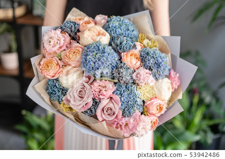 Beautiful bouquet of mixed flowers in woman hand. Floral shop concept . Handsome fresh bouquet 53942486