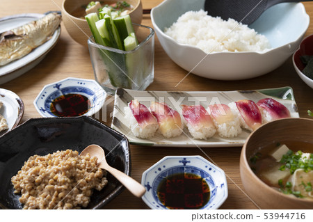 Hand-rolled sushi and a handful of chopsticks Hand-rolled sushi and a handful of chopsticks 53944716