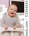 Happy smiling cute toddlersitting in the baby chair. Concept of happiness 53944845