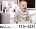 Happy smiling cute toddlersitting in the baby chair. Concept of happiness 53944889
