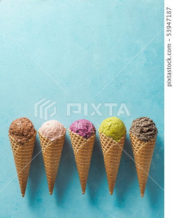 ice cream scoops in cones with copy space on blue ice cream scoops in cones with copy space on blue 53947187