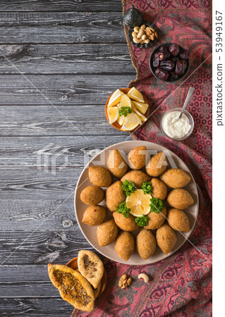 Traditional Arabic kibbeh with lamb and pine nuts. Traditional Arabic kibbeh with lamb and pine nuts. 53949167