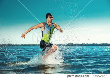 Professional triathlete swimming in river's open water Professional triathlete swimming in river's open water 53952638
