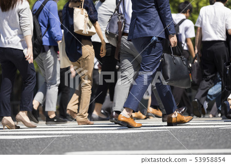 A businessman crossing a pedestrian crossing A businessman crossing a pedestrian crossing 53958854