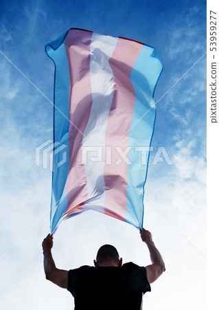 young person with a transgender pride flag young person with a transgender pride flag 53959277