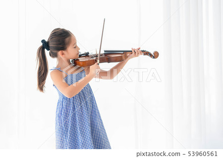 Cute girl playing violin in white bedroom with Cute girl playing violin in white bedroom with 53960561