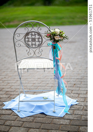Chair with  flowers and towels 53961751