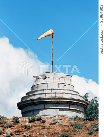Windsock on stone tower, industrial style Windsock on stone tower, industrial style 53964902