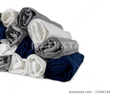 Colours rolled t-shirts di cut on white wallpaper. 53966146