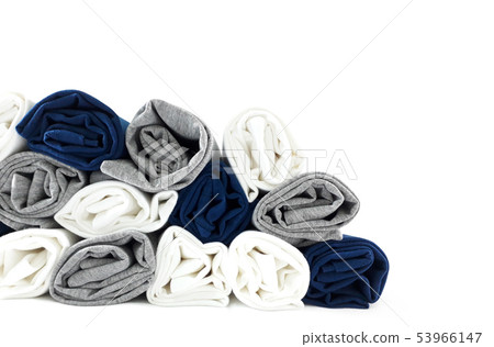 Colours rolled t-shirts di cut on white wallpaper. 53966147