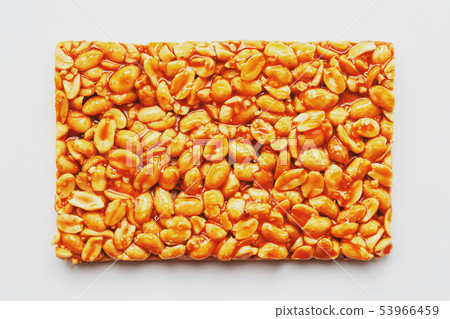 Healthy snacks. Fitness diet food. Kozinaki fritters made from roasted peanuts, energy bars. White 53966459