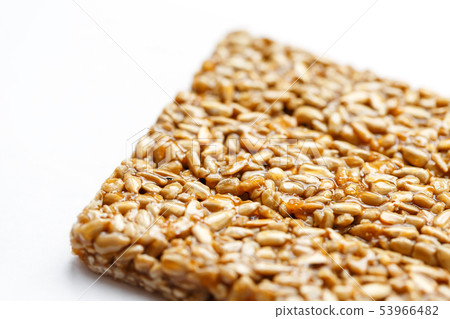 Healthy snacks. Fitness diet food. Kozinaki fritter, seeds, energy bars. White background top view Healthy snacks. Fitness diet food. Kozinaki fritter, seeds, energy bars. White background top view 53966482