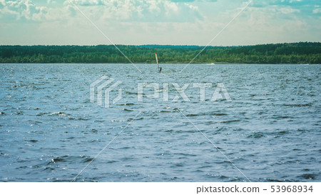 Alone windsurfer catches the wind Alone windsurfer catches the wind 53968934