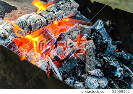 Hot coals in bbq pit 53969102