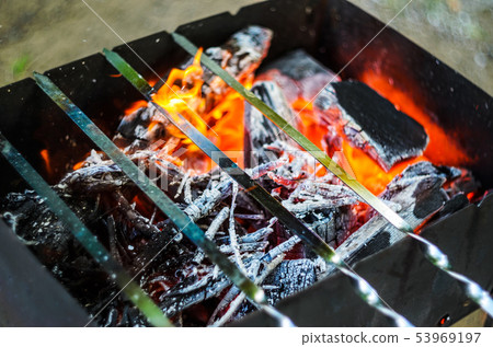 Hot coals in bbq pit 53969197
