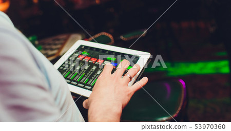 studio working with sound and light mixer console,hands of sound engineer working on recording studio working with sound and light mixer console,hands of sound engineer working on recording 53970360