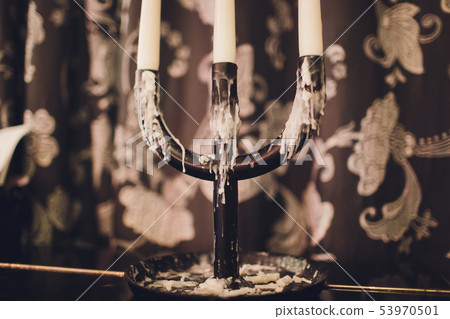 Triple vintage candlestick made of glass and black metal, two white stearin candles and one candle Triple vintage candlestick made of glass and black metal, two white stearin candles and one candle 53970501
