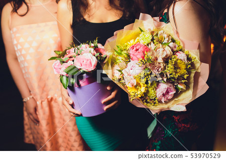 Two Small Beautiful bouquets of mixed flowers in woman hand. Floral shop concept . Beautiful fresh Two Small Beautiful bouquets of mixed flowers in woman hand. Floral shop concept . Beautiful fresh 53970529