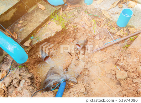 broken pipe in hole with water motion at roadside broken pipe in hole with water motion at roadside 53974080