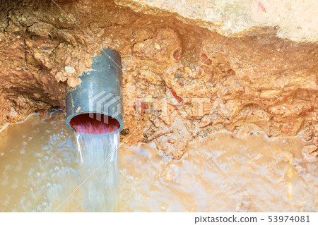 broken pipe in hole with water motion at roadside broken pipe in hole with water motion at roadside 53974081