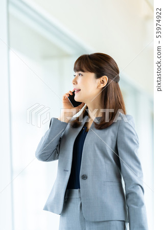 Business woman making phone call Business image Female employee Business woman making phone call Business image Female employee 53974922