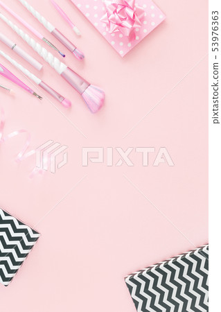 unicorn makeup brushes and gift boxes on pink 53976363