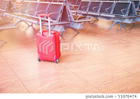 Suitcase at the airport waiting area 53976474