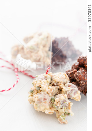 Rocks with chocolate and nuts. Christmas theme. Healthy sweet dessert snack. Granola bar with nuts Rocks with chocolate and nuts. Christmas theme. Healthy sweet dessert snack. Granola bar with nuts 53978341