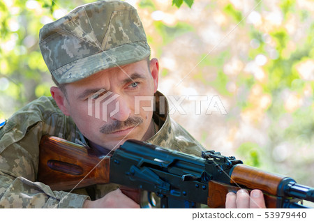 Ukrainian soldier in the battle with a rifle Ukrainian soldier in the battle with a rifle 53979440