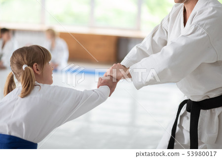 Cute girl preparing for sport competition practicing aikido 53980017