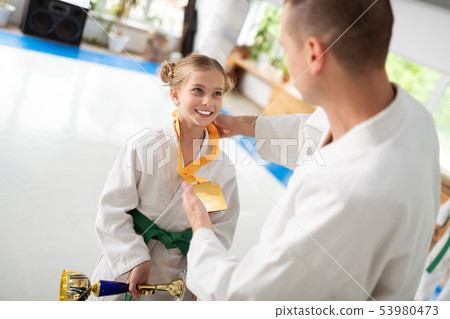 Cheerful girl loving kimono smiling while receiving prizes 53980473