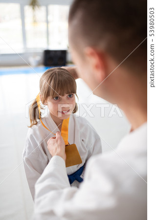 Girl feeling amazing while receiving medal after winning fight 53980503