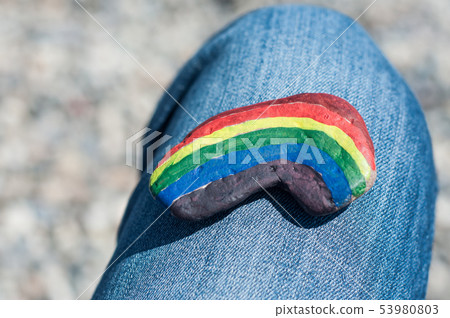 Closeup of rainbow painting on stone pebble Closeup of rainbow painting on stone pebble 53980803