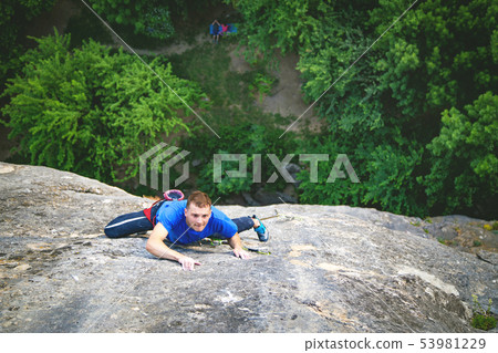 Man climbs rock. 53981229