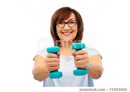 smiling senior woman with dumbbells exercising 53983608