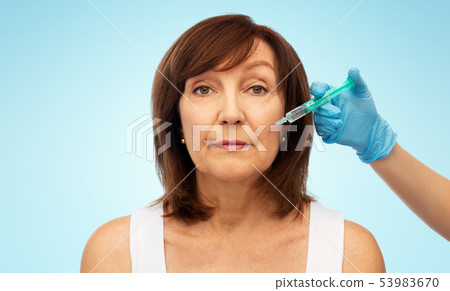 senior woman and surgeon hand with syringe senior woman and surgeon hand with syringe 53983670
