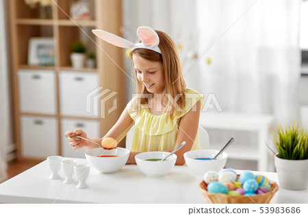 girl coloring easter eggs by liquid dye at home girl coloring easter eggs by liquid dye at home 53983686