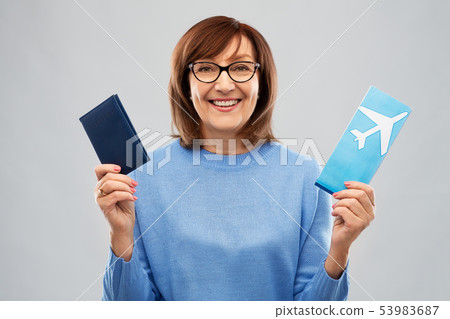 senior woman with passport and airplane ticket senior woman with passport and airplane ticket 53983687
