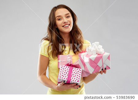 young woman or teenage girl with birthday gifts 53983690