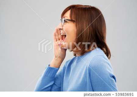 senior woman in glasses calling over grey senior woman in glasses calling over grey 53983691