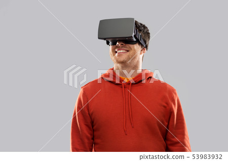 happy man in virtual reality headset or vr glasses 53983932