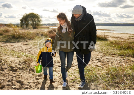 happy family walking along autumn beach 53984098