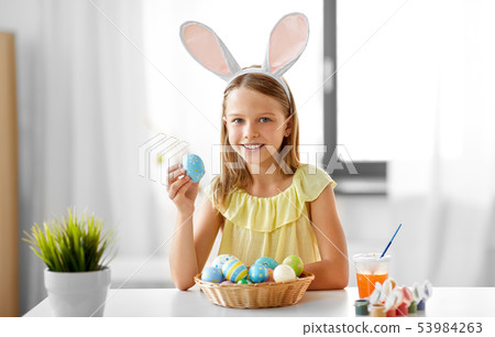 happy girl with colored easter eggs at home happy girl with colored easter eggs at home 53984263